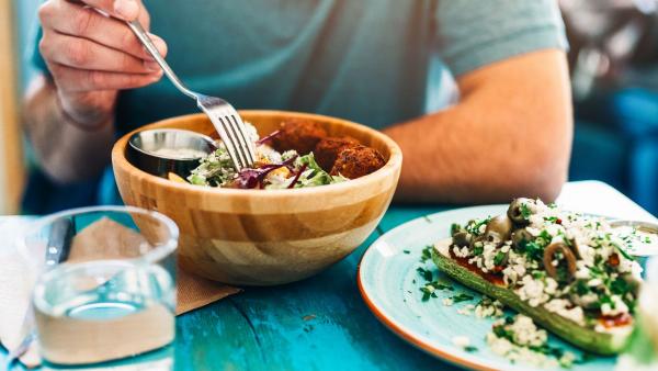 Man eating a vegan salad