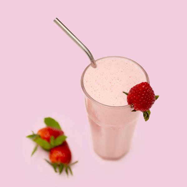 Strawberry Protein Beverage in glass with straw