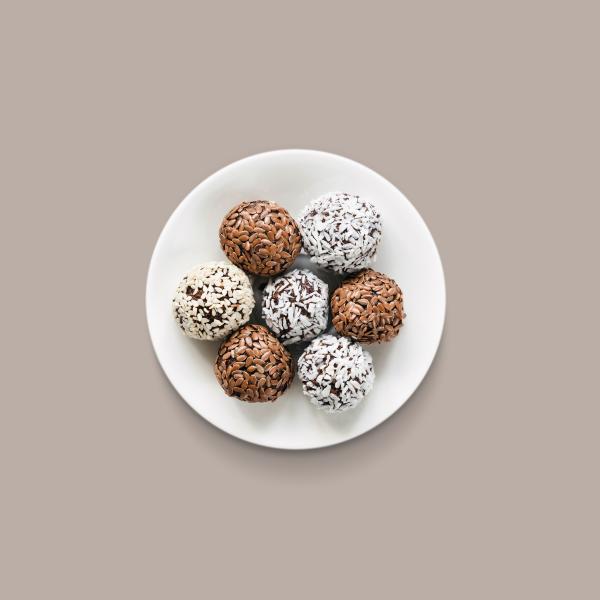 Seven protein fortified food balls on a white plate