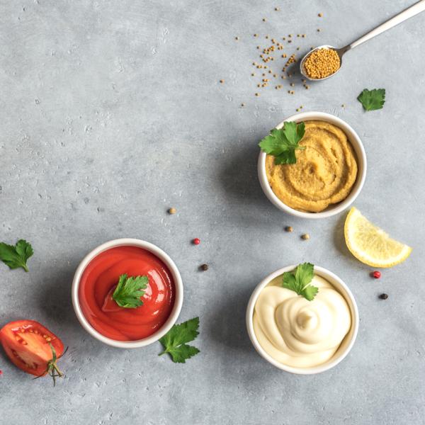 A selection of three dips on a slate background.