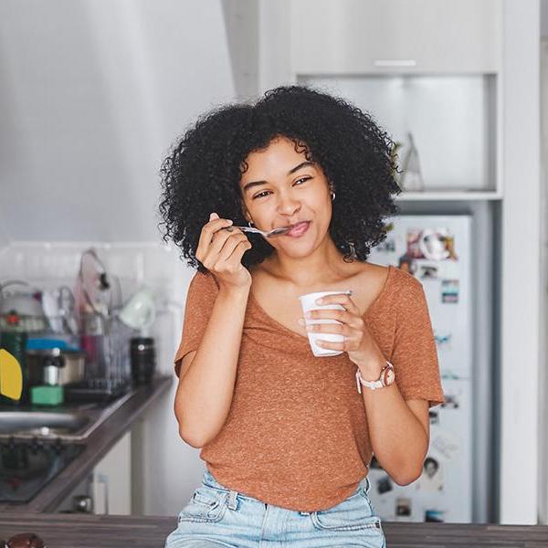 women eating food in kitchen