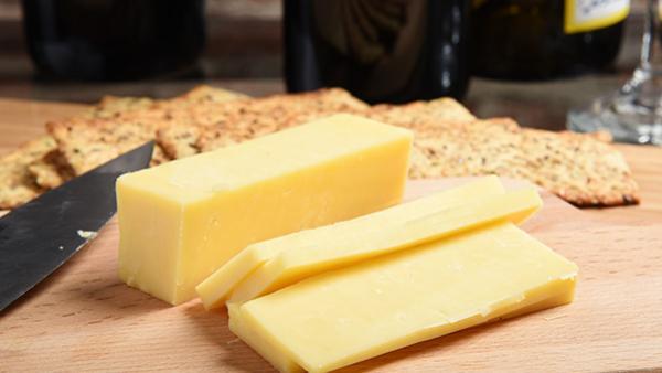 block of cheese on a board