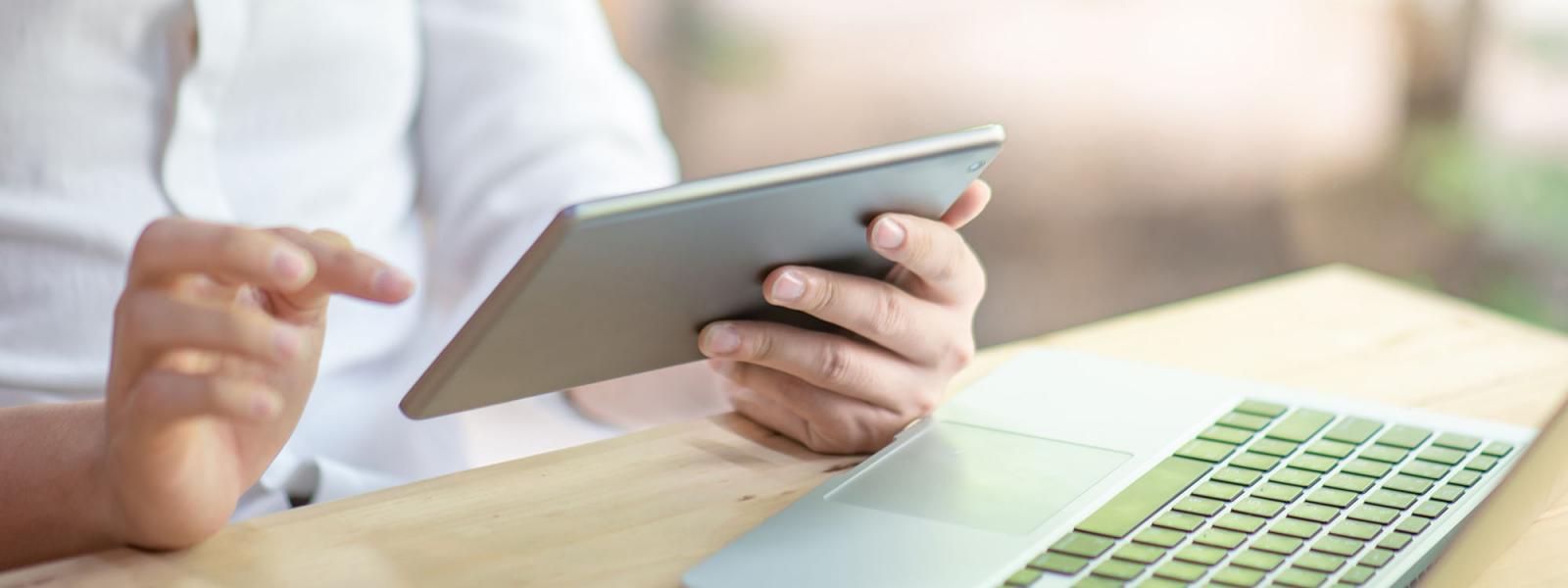 Man reading Glanbia Ireland Ingredients news on an iPad