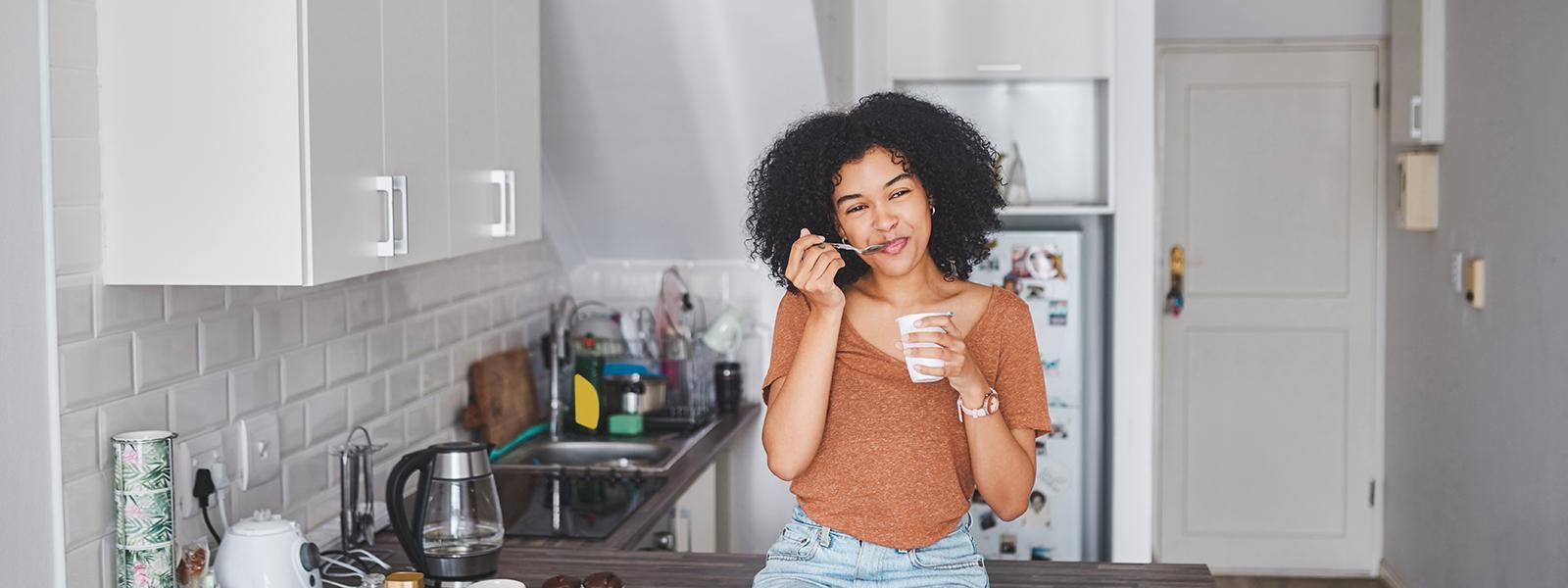 women eating food in kitchen